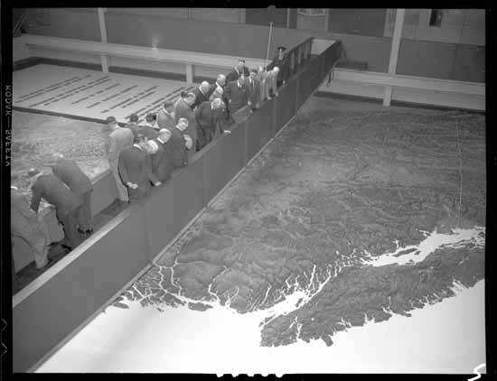 Black-and-white photo of bankers on a walkway over British Columbia