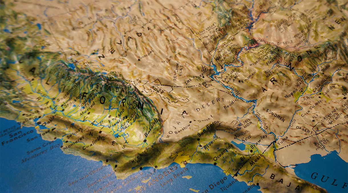 A macro photo of a raised relief map of the California coast