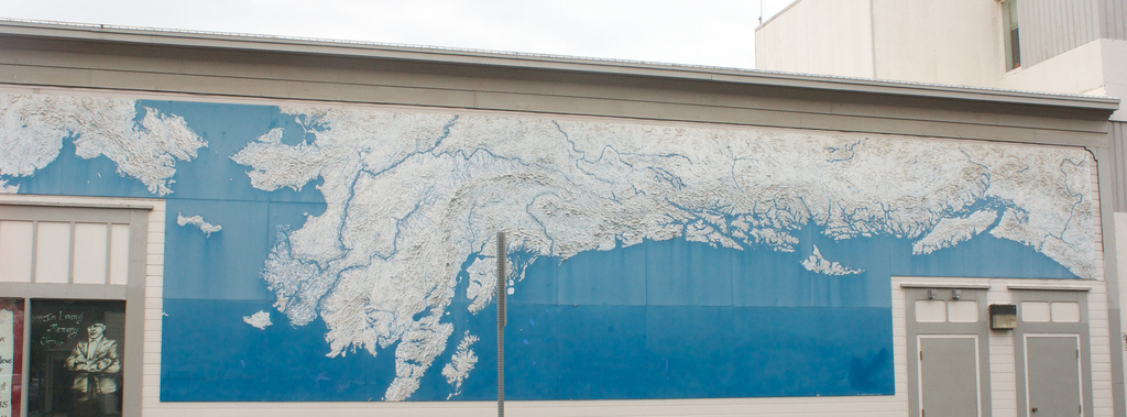 A very large map of the Pacific Northwest coast on the side of a building
